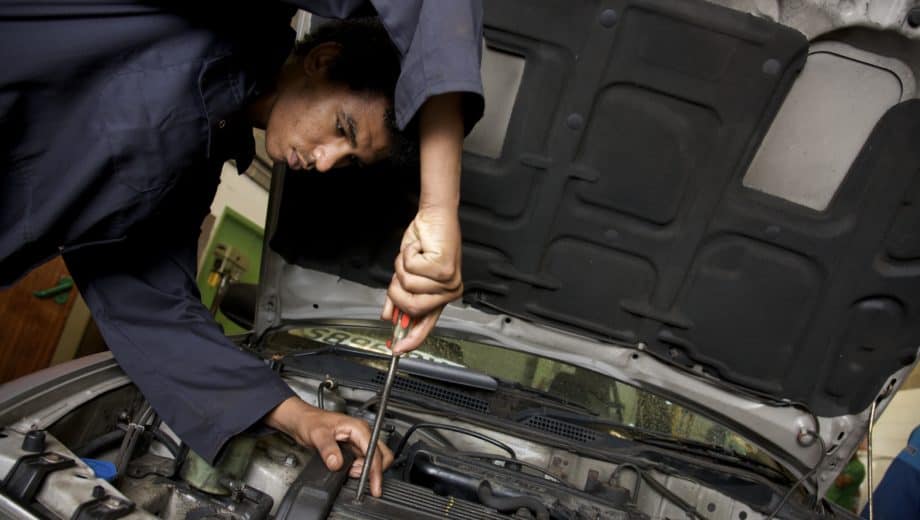 person working on a car motor